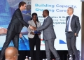 Valerian PFRIMMER, Managing Director for East and South Africa at SLB hands over the programme implementation agreement to Prof. Jude T. Lubega the Vice Chancellor of Nkumba University