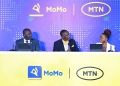 Brian Mulondo (C) moderates the MTN MoMo Power to be More campaign Launch with MTN's Richard Yego (L) and Jemima Kariuki (R)