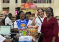 Flexipay cashback Trolley Dash winner Kyomuhendo Leticia ejoying her moment as she checked out of the supermarket