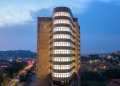 Pearl Tower One, part of the new Pearl Business Park, stands illuminated in the Kampala night skyline.