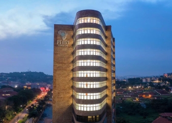 Pearl Tower One, part of the new Pearl Business Park, stands illuminated in the Kampala night skyline.