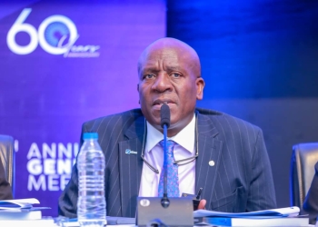 Charles M. Mudiwa, chief executive officer of dfcu Bank, addresses shareholders at the company's 60th Annual General Meeting in Kampala on Friday.