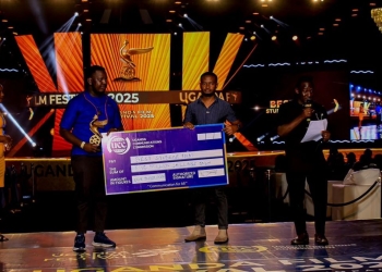 Emma Illungole (L) and Kefa Senoga (R) recieving the Award on behalf of Brian Kabogozza and Douglas Byaruhanga