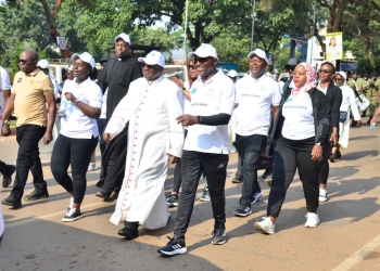 Archbishop of Kampala Archdiocese, His Grace Paul Ssemwogerere, Fabian Kasi, Managing Director, Centenary Bank (R) and other walkers during the Nsambya Babies Home Charity Walk.