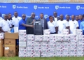 Stanbic Bank Staff Members led by Tunde Thorpe, Executive Head Business Commercial Banking Handover the vital equipement to Dr. Brian Kisembo Ast. DHO Kabarole District