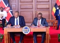 Uganda Investment Authorityu's Director General Robert Mukiza and his Kenyan counterpart signing an MOU on Investment promotions at Nairobi State house on Wednesday as Presidents Museveni (L) and Ruto (R) l