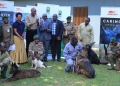 Some of the dog handlers with their dogs and other stakeholders during the hand over ceremony in Entebbe on Tuesday.