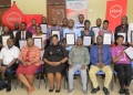 Absa Bank Uganda's Ag. Head of Markets Catherine Kijjagulwe (in maroon dress), with Makerere University officials and journalists after the masterclass