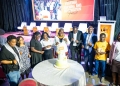 Minister Peace Mutuuzo and other officials during the Cake cutting ceremony.
