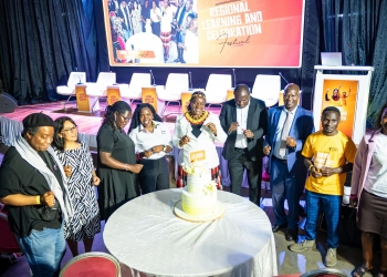 Minister Peace Mutuuzo and other officials during the Cake cutting ceremony.