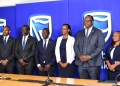 Stanbic Bank leadership led by Chief Executive Mumba Kalifungwa pose for a group photo after releasing half year financial results at Crested towers in Kampala
