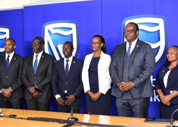 Stanbic Bank leadership led by Chief Executive Mumba Kalifungwa pose for a group photo after releasing half year financial results at Crested towers in Kampala