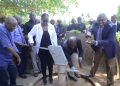 Sheila Sabune, the Corporate Relations Director and Hon.Okasai Opolot operate the borehole as Jimmy Biyomotho , Ministry of Water and Environment Regional Manager (in necktie) washes his hands