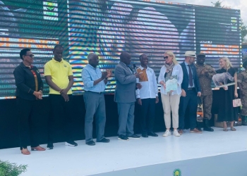 The British High Commissioner H.E. Lisa Chesney receives a plaque from the Minister of Public Service and Minister of Tourism for the UK's support to Uganda's tourism sector