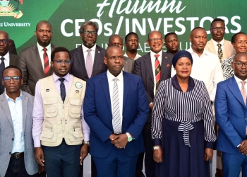 Stanbic Bank Executive Director, Samuel Fredrick Mwogeza (3L) second row, Makerere University Vice-chancellor, Barnabas Nawangwe (3R) second row, Balaam Barugahara, the Minister of State for Youth and Children Affair