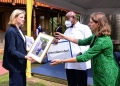 Austria's Foreign Affairs Minister Beate Meinl-Reisinger (L) showing President Museveni some historical photos from Austria during a meeting on the sidelines of the NAM Ministerial meeting at Munyonyo on We