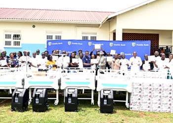 Stanbic Bank delegation pose for a group with the Kasese district leadership during the equipement handover event at Rukoki Hospital in Kasese district