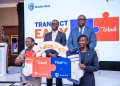 Pearl Bank Managing Director Julius Kakeeto and Stanbic Bank Managing Director Mumba Kenneth Kalifungwa, back row, pose with Priscilla Akora, head of marketing and communications at Pearl Bank, and Diana Kahunde, head of brand and marketing at Stanbic Bank, holding a collaboration sign on Oct. 23, 2025. The banks integrated their digital wallets, Wendi and FlexiPay, to reduce transaction fees and expand financial access in Uganda.