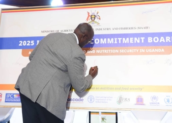 Bright Kanyontore Rwamirama, Uganda's minister of state for Animal Industry, signs a summary board Wednesday following the release of the Integrated Food Security Phase Classification (IPC) report on acute food insecurity in Kampala.