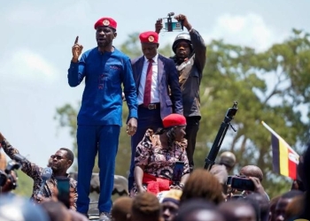 Robert Kyagulanyi, the National Unity Platform's presidential candidate, speaks to a crowd in Namwendwa Town Council, Uganda, on Tuesday. Kyagulanyi used the rally to pledge a nationwide school feeding program to combat high dropout rates and protect vulnerable girls.