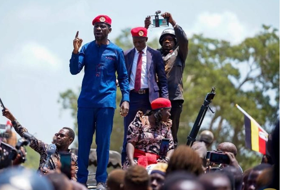 Robert Kyagulanyi, the National Unity Platform's presidential candidate, speaks to a crowd in Namwendwa Town Council, Uganda, on Tuesday. Kyagulanyi used the rally to pledge a nationwide school feeding program to combat high dropout rates and protect vulnerable girls.