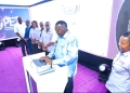 Chief Justice Alfonse Owiny Dollo testing the PET tool at the Go live event on Friday as other Judicial staff look on.