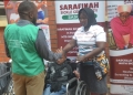 One of the beneficiaries receiving a wheel chair from Sarafina.