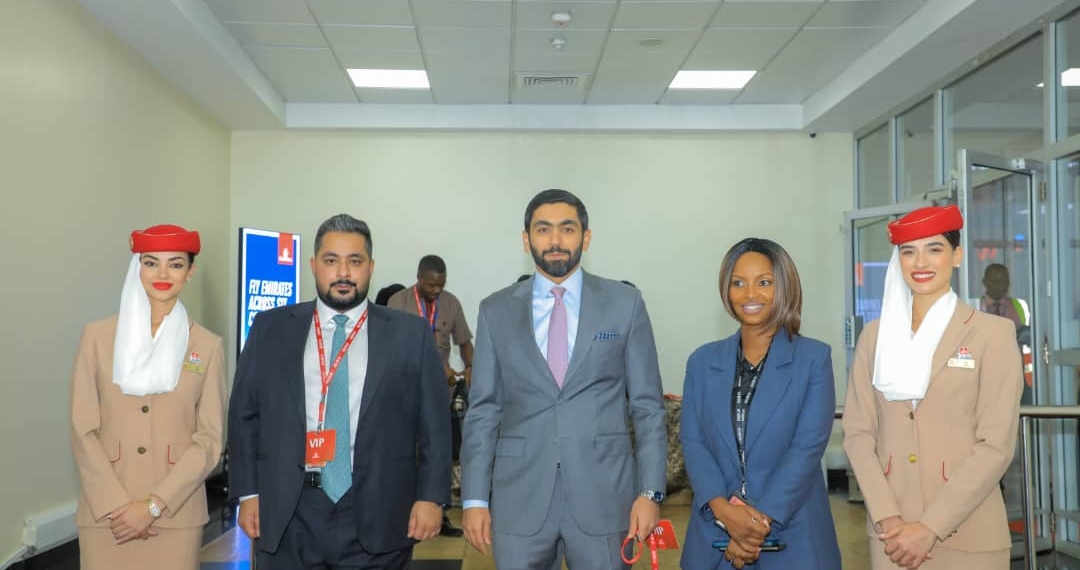 (L-R) An Emirates crew member, Mohamed Taher, country manager for Uganda, Rashid Alardha, vice president of commercial operations, Sub-Saharan Africa, and Maureen Kabure, airport services manager in Uganda, stand during the unveiling of a refurbished Boeing 777 at Entebbe International Airport on Wednesday, Oct. 15, 2025.