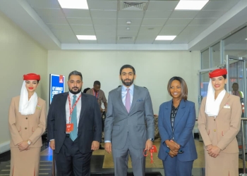 (L-R) An Emirates crew member, Mohamed Taher, country manager for Uganda, Rashid Alardha, vice president of commercial operations, Sub-Saharan Africa, and Maureen Kabure, airport services manager in Uganda, stand during the unveiling of a refurbished Boeing 777 at Entebbe International Airport on Wednesday, Oct. 15, 2025.