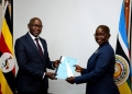 Incoming DPP, Mr. Lino Anguzu receiving a handover report from Lady Justice Jane Frances Abodo on Tuesday.