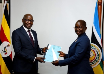 Incoming DPP, Mr. Lino Anguzu receiving a handover report from Lady Justice Jane Frances Abodo on Tuesday.