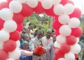 1:-The Deputy Resident District Commissioner of Kalangala, Henry Ssebunya (checked coat), commissioning the 10th new 4G mast site in the Kalangala Islands, marking a major step in the company’s nationwide network expansion program