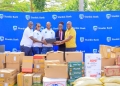 The Stanbic team led by Grace Semakula(middle), the Chief Executive of SBG Securities, handing over equipment to the school's director and headteacher.