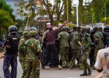 Ugandan opposition leader Bobi Wine surrounded by police during his campaign: PHOTO/facebook.com/www.bobiwine.ug