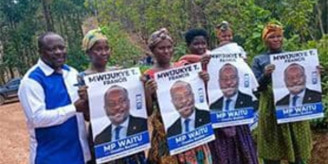 Supporters of Francis Mwijukye hold up his campaign portraits during a rally in Buhweju District ahead of the 2026 general elections. Mwijukye, a veteran legislator representing the People Front for Freedom, lost his seat in the polls after serving 15 years in Parliament.