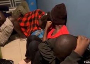 A group of Ugandans wait at a detention centre in Cambodia as the government begins efforts to repatriate up to 500 citizens stranded in Southeast Asia. Many of those held were victims of human trafficking syndicates and face heavy penalties for illegal stay after scamming compounds where they were forced to work were raided and closed by local authorities.