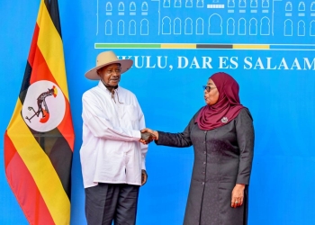 Ugandan President Yoweri Museveni, left, greets Tanzanian President Samia Suluhu Hassan in Dar es Salaam, Tanzania, on Sunday. The two leaders met to discuss regional security and the expansion of energy and trade cooperation between their nations.