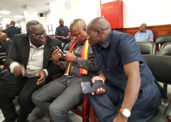 Robert Kasibante with his lawyers in Court today.