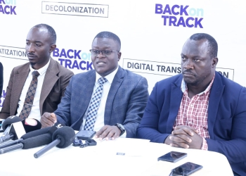 Ssali Babu (in middle) addressing the press