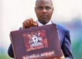 Uganda's Minister of Finance, Planning and Economic Development, Henry Musasizi, displays the National Budget briefcase ahead of delivering the FY2026/27 Budget Speech at Kololo Independence Grounds in Kampala. The UGX84.39 trillion budget prioritises transport infrastructure, security, education, health, agriculture, energy and industrialisation as government pursues its strategy of full monetisation of the economy and long-term growth towards a USD500 billion economy. Photo credit: Uganda Media Centre.