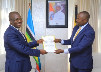 Former Minister of State for Foreign Affairs (Regional Cooperation) John Mulimba, right, hands over official management documents to his successor, Haruna Kasolo Kyeyune, during a formal ceremony at the Ministry of Foreign Affairs headquarters in Kampala, Uganda.