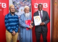 DTB Uganda MD, Mr. Godfrey Ssebaana (R), MD Universal enterprises Ltd, Mr. Muffadal Yeolawala (L), and CEO Universal Enterprises Ltd, Mr. Zoeb Yeolawala (2nd L) during the launch at the DTB head office, Kampala.