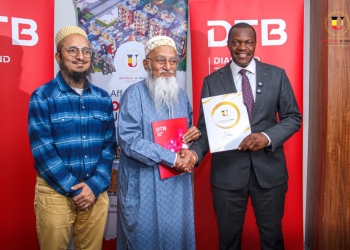 DTB Uganda MD, Mr. Godfrey Ssebaana (R), MD Universal enterprises Ltd, Mr. Muffadal Yeolawala (L), and CEO Universal Enterprises Ltd, Mr. Zoeb Yeolawala (2nd L) during the launch at the DTB head office, Kampala.